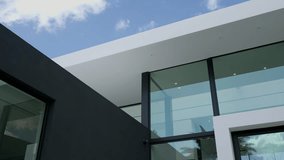 Modern commercial building under clear sky. Architecture including large glass windows and flat geometric rooflines. Dark facade creating minimalist atmosphere - Powered by Shutterstock - Get 15% off with code: PIKWIZARD15