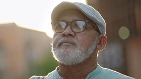 Senior inspired hispanic latino man in the city at sunset - Portrait of old retired person - Powered by Shutterstock - Get 15% off with code: PIKWIZARD15