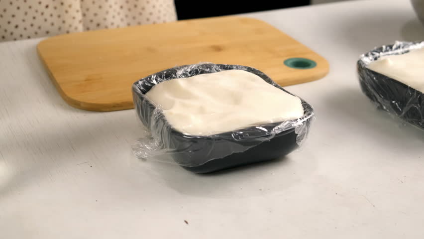 Woman cooking closing with file marshmallows mass to solidify in baking sheet on kitchen. Culinary cuisine baking food dish pastry. Preparing sweet homemade marshmallows apple dessert.