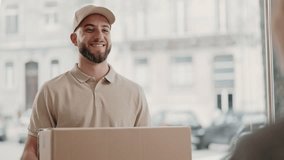 A friendly delivery man in a cap smiling as he hands over a package to a customer, capturing a moment of good service. - Powered by Shutterstock - Get 15% off with code: PIKWIZARD15