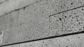 Close-up of a concrete wall showcasing rough texture and perforations, highlighting the rugged construction material and industrial aesthetics. Concrete Wall Texture with Perforations - Powered by Shutterstock - Get 15% off with code: PIKWIZARD15