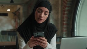 Pensive thoughtful islamic muslim girl Arabian business woman in hijab female businesswoman office worker student think dream ponder consider idea using mobile phone thinking typing message smartphone - Powered by Shutterstock - Get 15% off with code: PIKWIZARD15