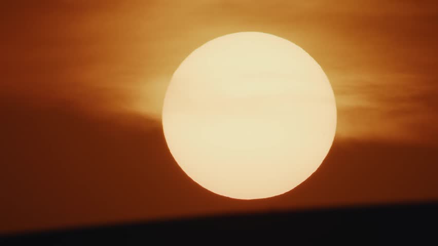 A full sun dominating the frame, the clear, intense colors and the minimalistic horizon line enhance the suns glowing majesty.