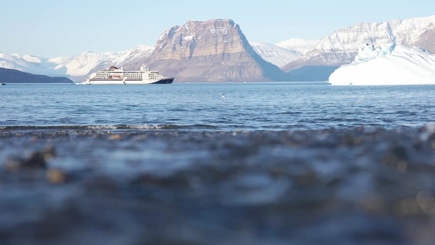 Greenland, Northeast National Park, Glacial Water Flowing Into the Sea on Sunny Spring Day, Low Angle Slow Motion