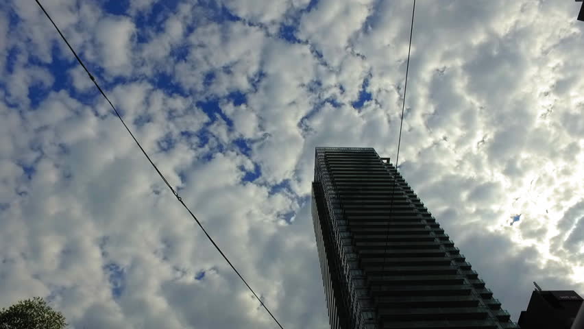 Panning Low Angle View Of Tall Residential Building Under Cloudy Sky - Toronto, Canada