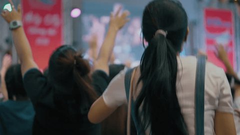 
Youths and teenagers are joyfully jumping, dancing, and raising their hands at the music festival concert in Thailand, singing worship songs, praying together to God, and experiencing spiritual reviv: film stockowy