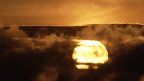 Beautiful evening sunset time lapse. Big orange sun set over horizon close-up. Hot huge yellow star. Warm golden sundown closeup. Scenic sky sunrise background. Cloudy weather. Nature beauty landscape - Powered by Shutterstock - Get 15% off with code: PIKWIZARD15