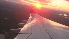Passenger air plane fly high above sky. View from aircraft porthole. Comfortable fast airplane travel. Aviation concept. Airliner flight beautiful sunset. Fun summer journey. Wing of jet from window. - Powered by Shutterstock - Get 15% off with code: PIKWIZARD15