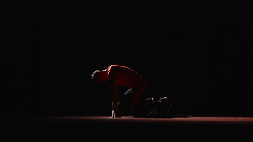 Cinematic Shot Of Runner On Start, Silhouette Of Athletic Man In Darkness, Starting And Running