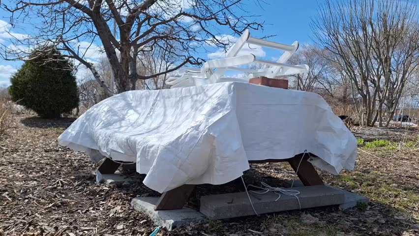 Covered picnic table with white plastic wrap