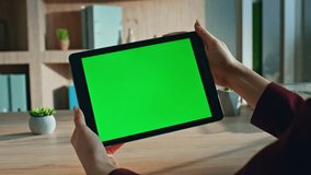 Girl watching webinar at mockup tablet sitting agency office desk close up. Unknown businesswoman looking on green screen pad computer at office. Entrepreneur browsing online app on chroma key gadget. - Powered by Shutterstock - Get 15% off with code: PIKWIZARD15