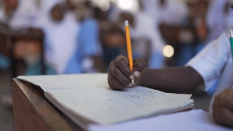 Focus on the hand of a black kid in the classroom - Education concept స్టాక్ వీడియో