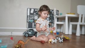 baby child playing toys animals on floor in kindergarten. happy family kid concept. baby play toys animals scattered on indoors. development of fine motor skills concept lifestyle - Powered by Shutterstock - Get 15% off with code: PIKWIZARD15
