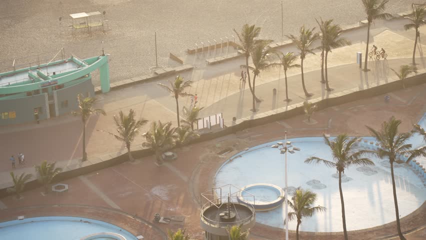 Elevated view of people cycling on promenade in Durban at sunrise, Durban, KwaZulu-Natal Province, South Africa, Africa