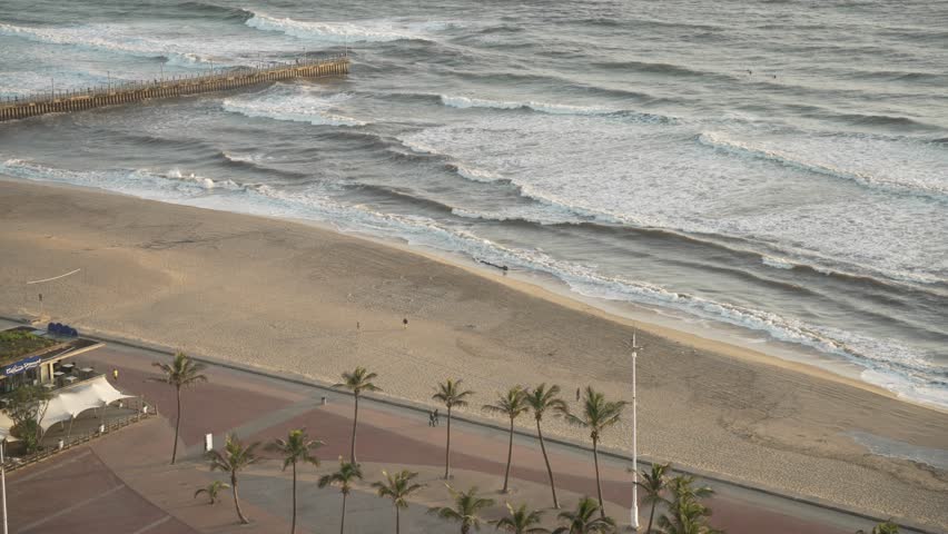 Elevated view of cafe and people on promenade in Durban at sunrise, Durban, KwaZulu-Natal Province, South Africa, Africa