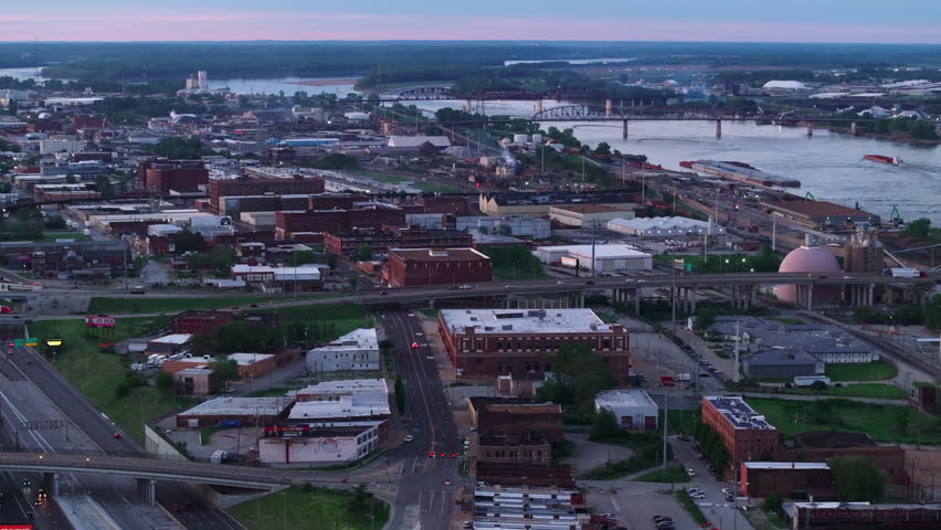 Aerial view of St. Louis, missouri at dusk, highlighting the cityscape, streets, and Mississippi River and its bridges in the backdrop