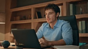 Online worker finish project in dark office close up. Smiling male freelancer closing laptop feeling success at evening home workplace. Inspired man writer typing essay on computer sitting modern desk - Powered by Shutterstock - Get 15% off with code: PIKWIZARD15