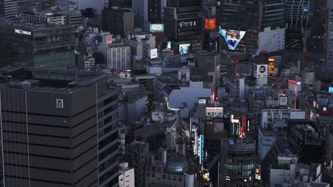 Aerial view of dense town development in city. Streets and buildings in Shibuya district in evening. Tokyo, Japan, February 10, 2024のエディトリアル動画素材