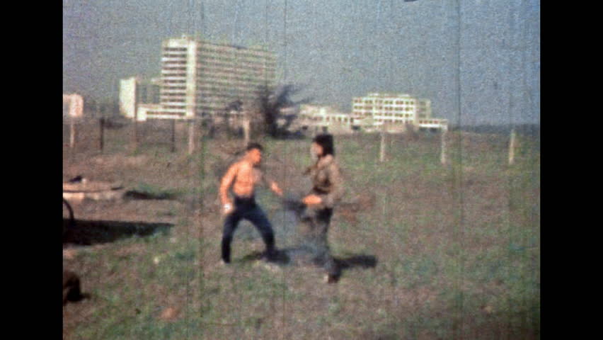 Asian combat between karate masters. Professional fighting arts. Men flying, jumping use fight exercise in sport training. Japan defense. martial protection. Vintage color film. Retro 1980s archive