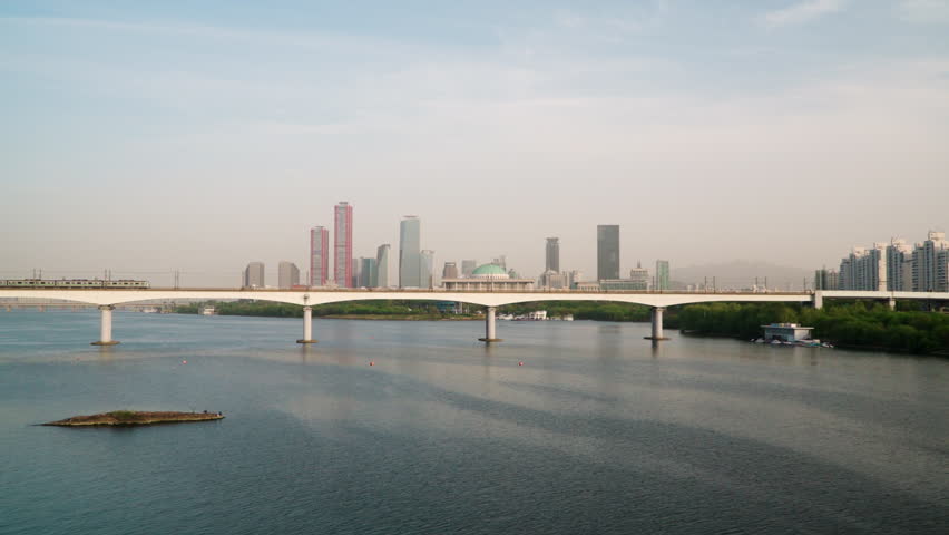 Train At Dangsan Railway Bridge With National Assembly Building In Background. Yeongdeungpo, Seoul, South Korea. zoom-in