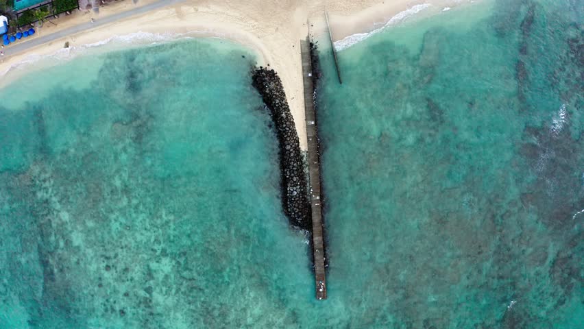 Overhead drone shot of the Waikiki Fireworks Watch jetty in Oahu.