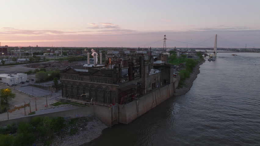 Aerial view of Ashley Street Power House industrial area by Mississippi River in St. Louis at sunset, showcasing bustling activity and serene beauty of waterway