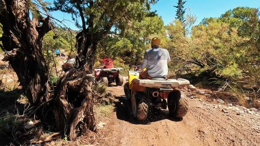 Safari Ride With ATV Quad Bikes Through the Kemer, Turkey. Adventures of Off-road on ATV. Mountains, Rocks and River Road Quad Cycle Travel. Excursion With People POV 4K Slow Motion Video.