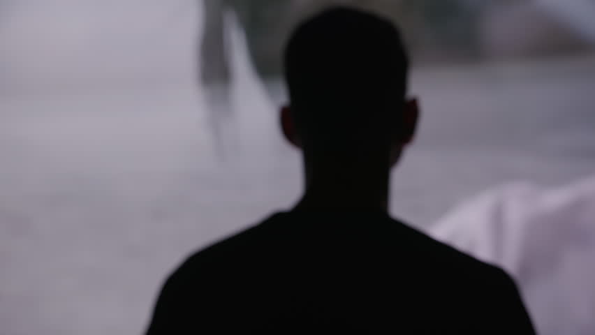 Back view of man standing in a dark environment Life Flashing in front of his eyes religious experiences