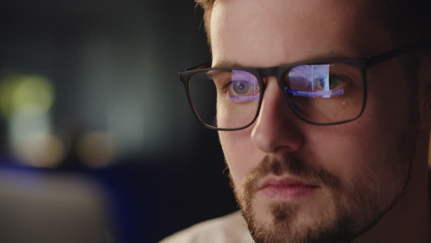 Close up shot of wearing glasses with reflect ukrainian attacked by russia in 2022 february. Video flashbacks about russian invasion. Upset man shocked looking first cadres from Bucha