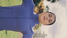 Sport girl jumping park at cloudy nature vertical closeup. Active lady training body looking distance at green lawn place. Slim strong woman practicing star exercises enjoying daily cardio workout - Powered by Shutterstock - Get 15% off with code: PIKWIZARD15