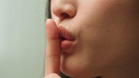 Close up female mouth Asian chinese korean japanese girl unrecognizable woman showing hush lips secret silence quite secrecy confidential mysterious whisper silent hand gesture face details in studio - Powered by Shutterstock - Get 15% off with code: PIKWIZARD15