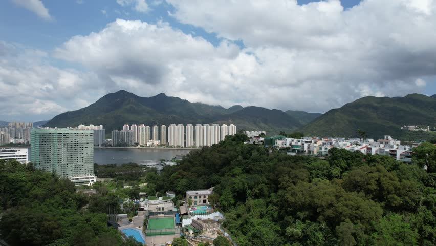 Aerial tour over the exclusive low-density villa estates and luxury residences nestled on the slopes of Hong Kong Kau To Shan near Sha Tin CUHK
