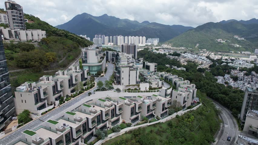 Aerial tour over the exclusive low-density villa estates and luxury residences nestled on the slopes of Hong Kong Kau To Shan near Sha Tin CUHK