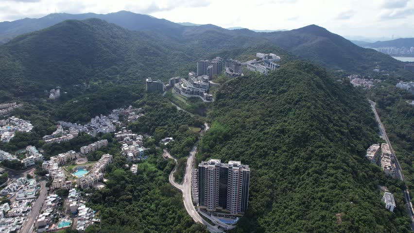 Aerial tour over the exclusive low-density villa estates and luxury residences nestled on the slopes of Hong Kong Kau To Shan near Sha Tin CUHK