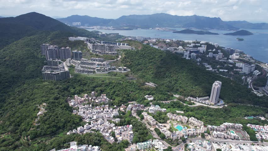 Aerial tour over the exclusive low-density villa estates and luxury residences nestled on the slopes of Hong Kong Kau To Shan near Sha Tin CUHK