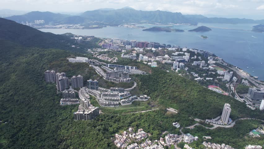 Aerial tour over the exclusive low-density villa estates and luxury residences nestled on the slopes of Hong Kong Kau To Shan near Sha Tin CUHK