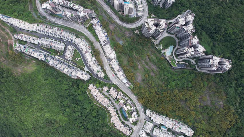 Aerial tour over the exclusive low-density villa estates and luxury residences nestled on the slopes of Hong Kong Kau To Shan near Sha Tin CUHK