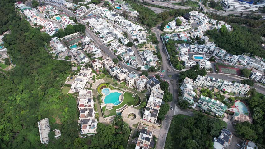 Aerial tour over the exclusive low-density villa estates and luxury residences nestled on the slopes of Hong Kong Kau To Shan near Sha Tin CUHK