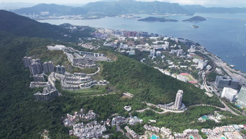 Aerial tour over the exclusive low-density villa estates and luxury residences nestled on the slopes of Hong Kong Kau To Shan near Sha Tin CUHK