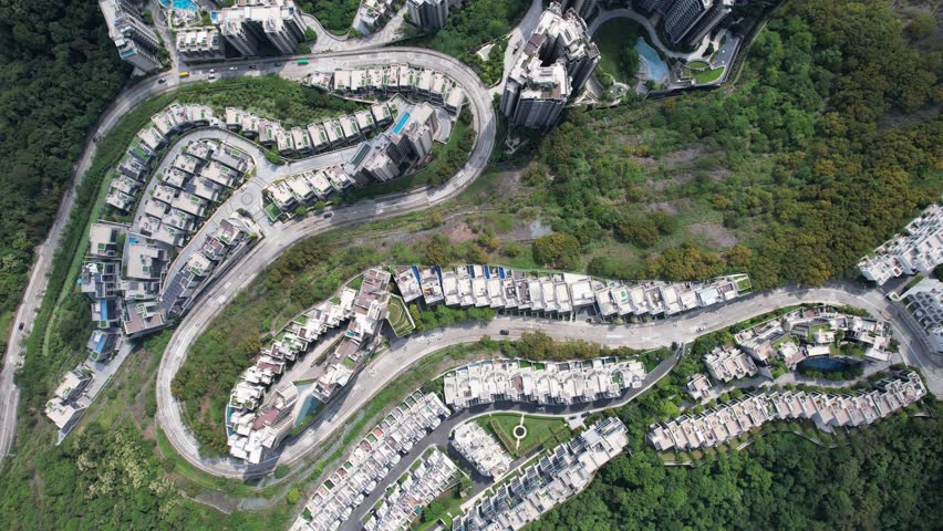 Aerial tour over the exclusive low-density villa estates and luxury residences nestled on the slopes of Hong Kong Kau To Shan near Sha Tin CUHK