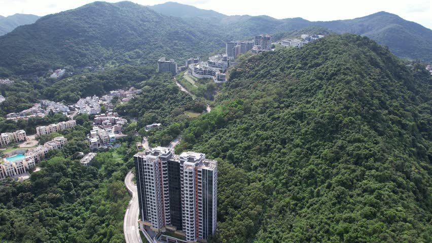Aerial tour over the exclusive low-density villa estates and luxury residences nestled on the slopes of Hong Kong Kau To Shan near Sha Tin CUHK