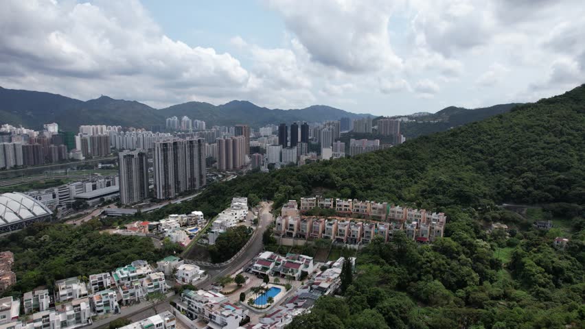 Aerial tour over the exclusive low-density villa estates and luxury residences nestled on the slopes of Hong Kong Kau To Shan near Sha Tin CUHK