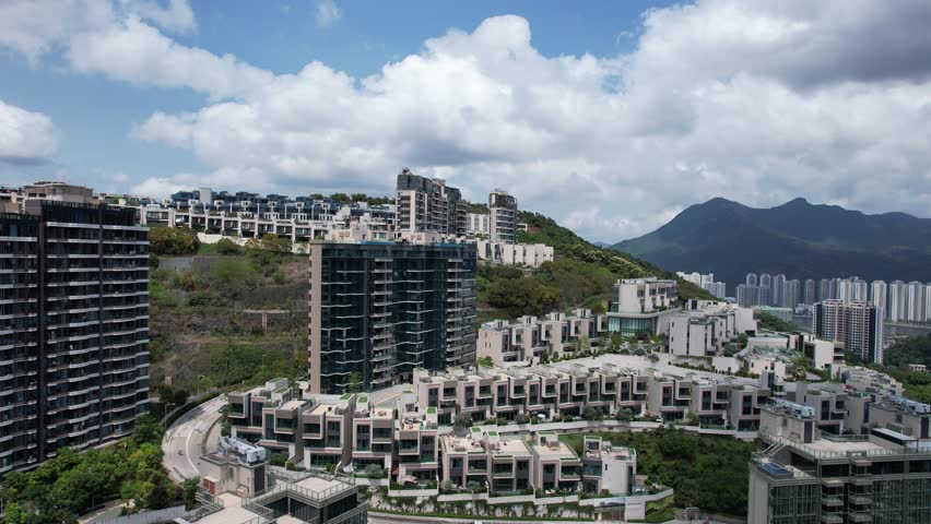 Aerial tour over the exclusive low-density villa estates and luxury residences nestled on the slopes of Hong Kong Kau To Shan near Sha Tin CUHK