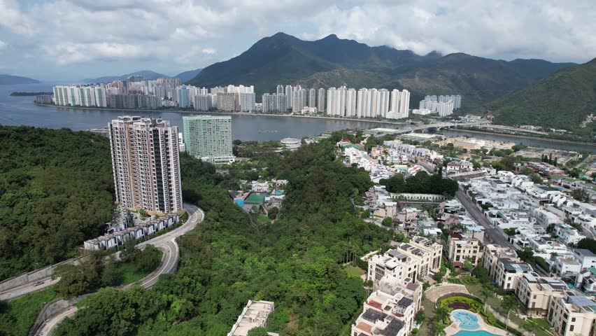 Aerial tour over the exclusive low-density villa estates and luxury residences nestled on the slopes of Hong Kong Kau To Shan near Sha Tin CUHK