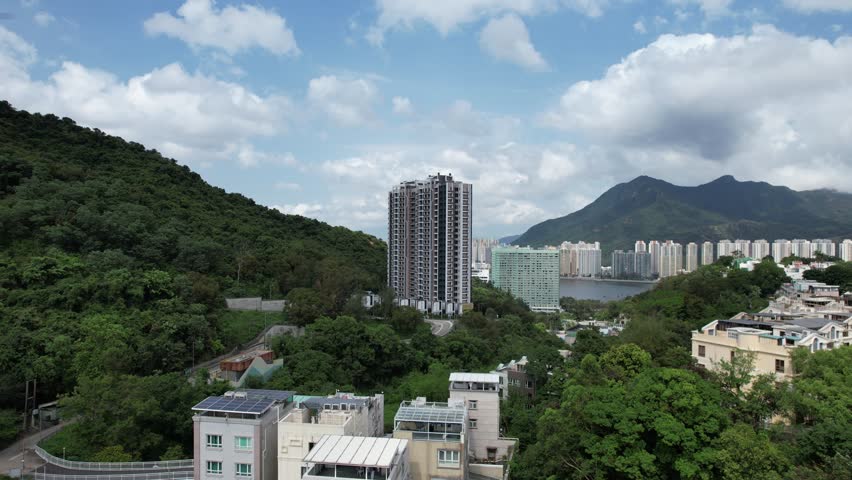 Aerial tour over the exclusive low-density villa estates and luxury residences nestled on the slopes of Hong Kong Kau To Shan near Sha Tin CUHK