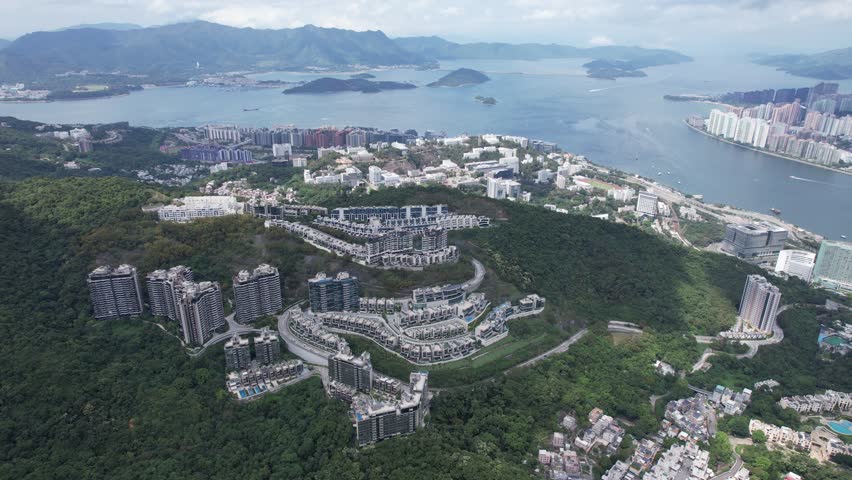 Aerial tour over the exclusive low-density villa estates and luxury residences nestled on the slopes of Hong Kong Kau To Shan near Sha Tin CUHK