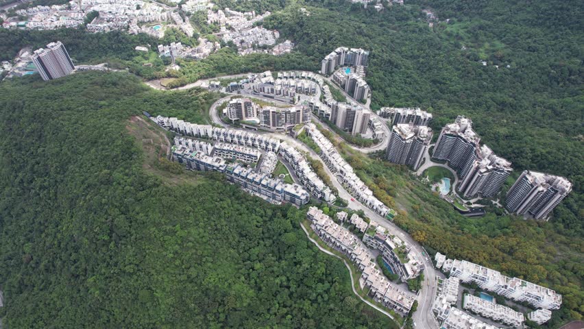 Aerial tour over the exclusive low-density villa estates and luxury residences nestled on the slopes of Hong Kong Kau To Shan near Sha Tin CUHK
