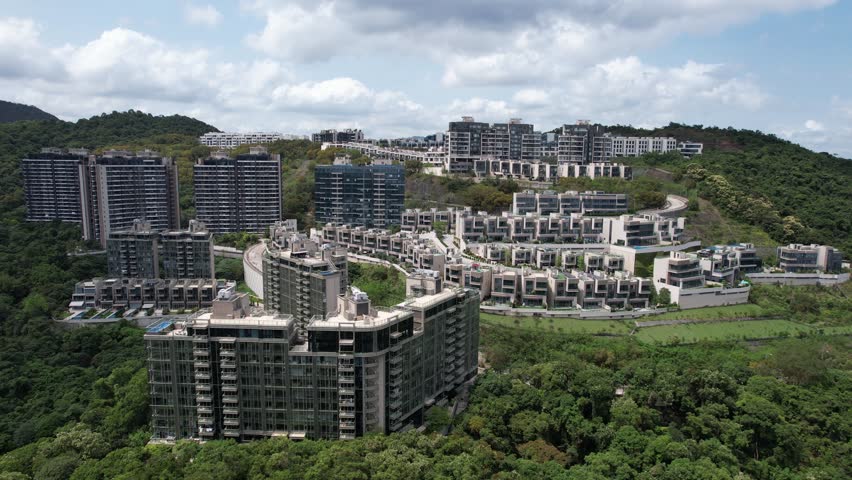 Aerial tour over the exclusive low-density villa estates and luxury residences nestled on the slopes of Hong Kong Kau To Shan near Sha Tin CUHK