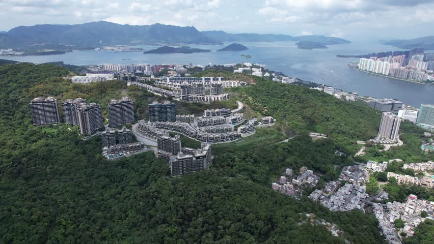 Aerial tour over the exclusive low-density villa estates and luxury residences nestled on the slopes of Hong Kong Kau To Shan near Sha Tin CUHK