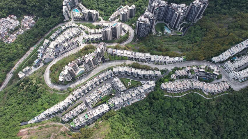 Aerial tour over the exclusive low-density villa estates and luxury residences nestled on the slopes of Hong Kong Kau To Shan near Sha Tin CUHK